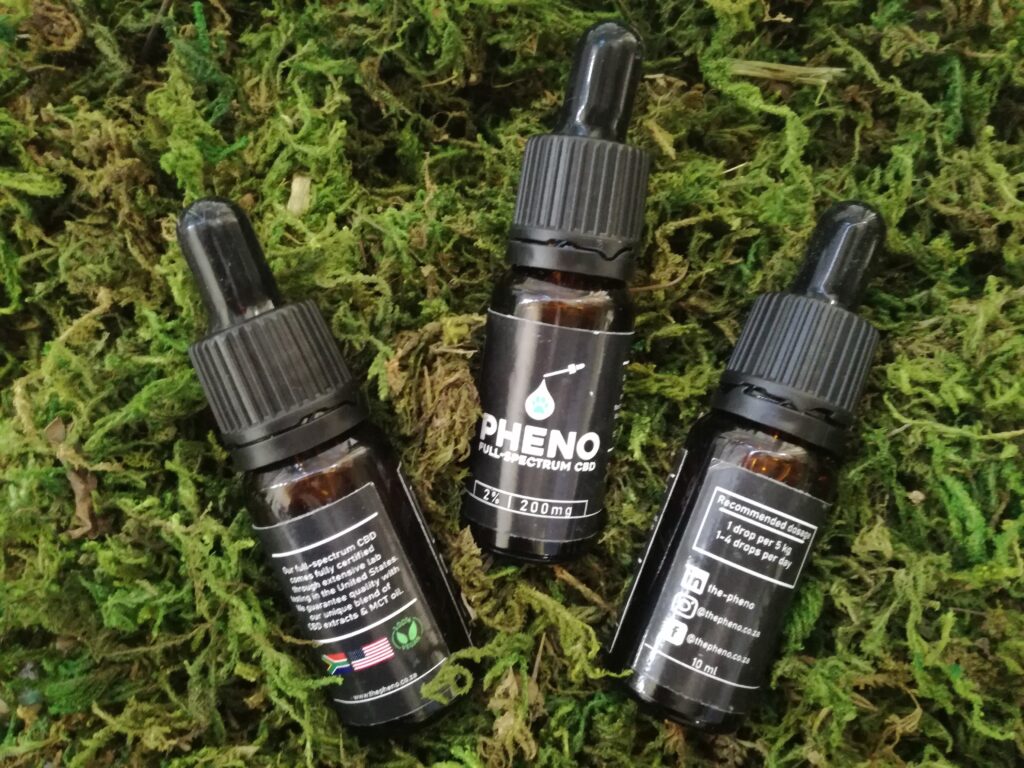 3 bottles of Pheno CBD oil lying in green moss