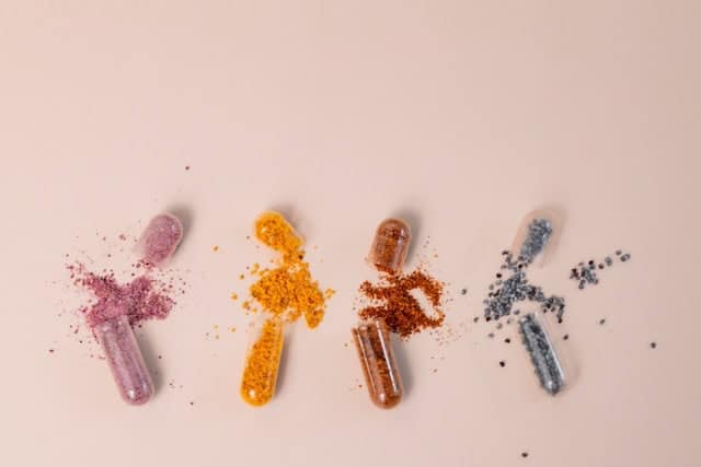 Colorful pills and powders representing mast cell cancer treatment options for dogs.